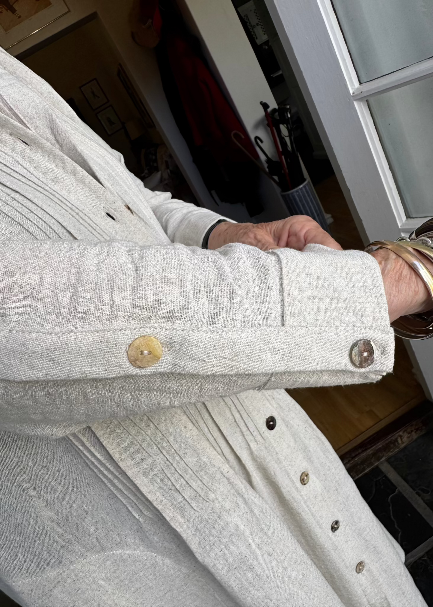 The Linen Pintuck Dress really can be worn in all seasons. It can be worn open as a coat, has side pockets with a two button cuff sleeve. Made from a linen blend which is a natural fabric.