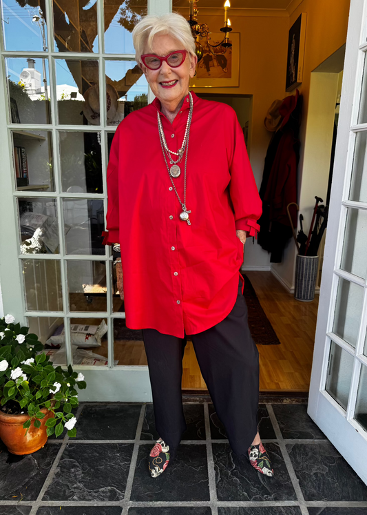 100% crisp cotton poplin women's shirt featuring dramatic back pleat with tied bow and decorative bow cuffs.