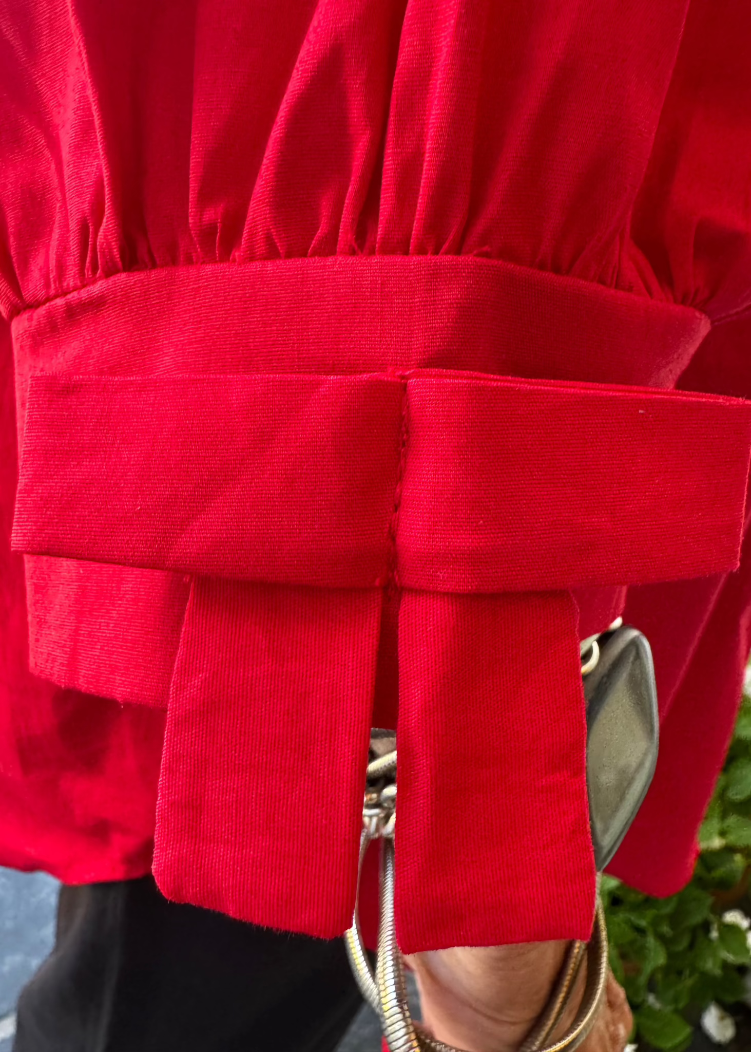 100% crisp cotton poplin women's shirt featuring dramatic back pleat with tied bow and decorative bow cuffs.