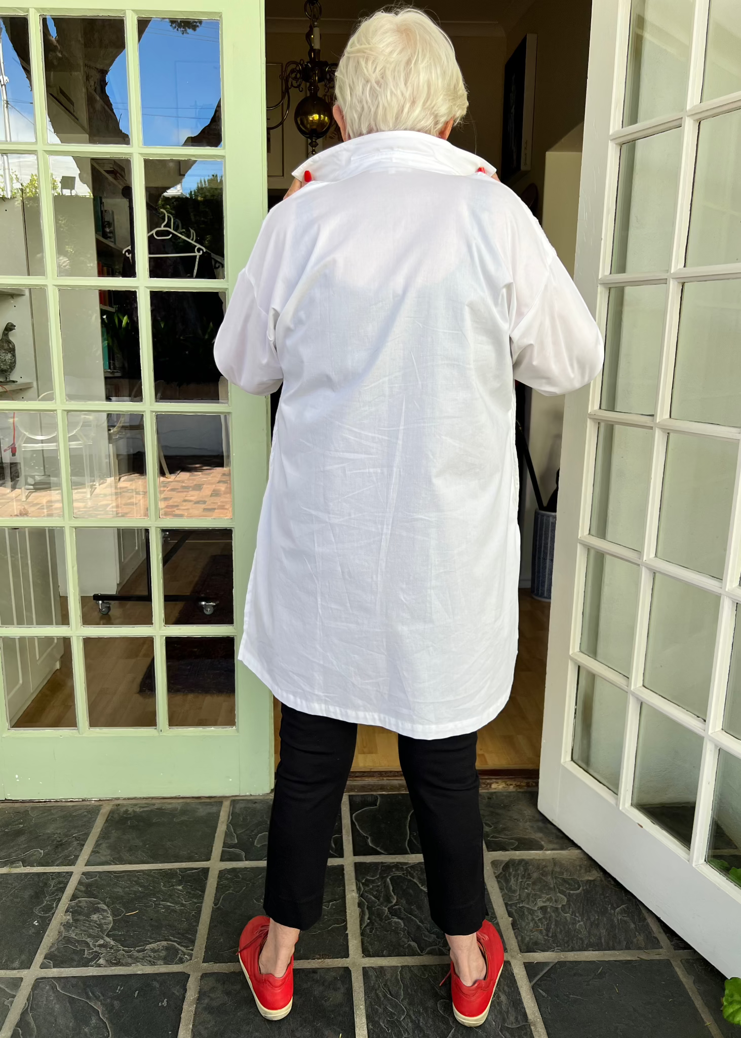 Crafted from crisp cotton with intricate pleating at the front and a sleek plain back, this exceptionally designed shirt offers the perfect balance of structure and flow. The elongated silhouette gracefully skims the body, providing an effortlessly slimming effect, while its generous length allows it to double as a lightweight jacket when left unbuttoned.