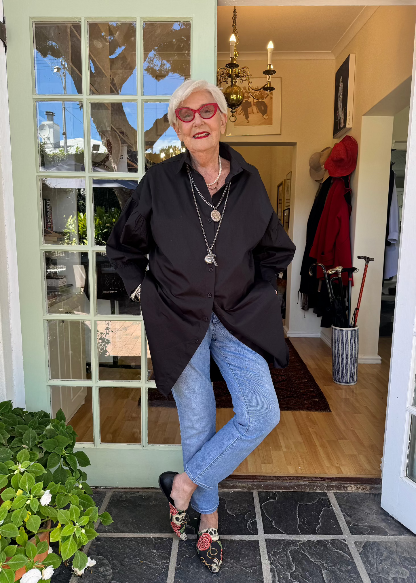 Jenny le Roux wearing a crisp black 100% cotton shirt, with a hint of a puff sleeve.