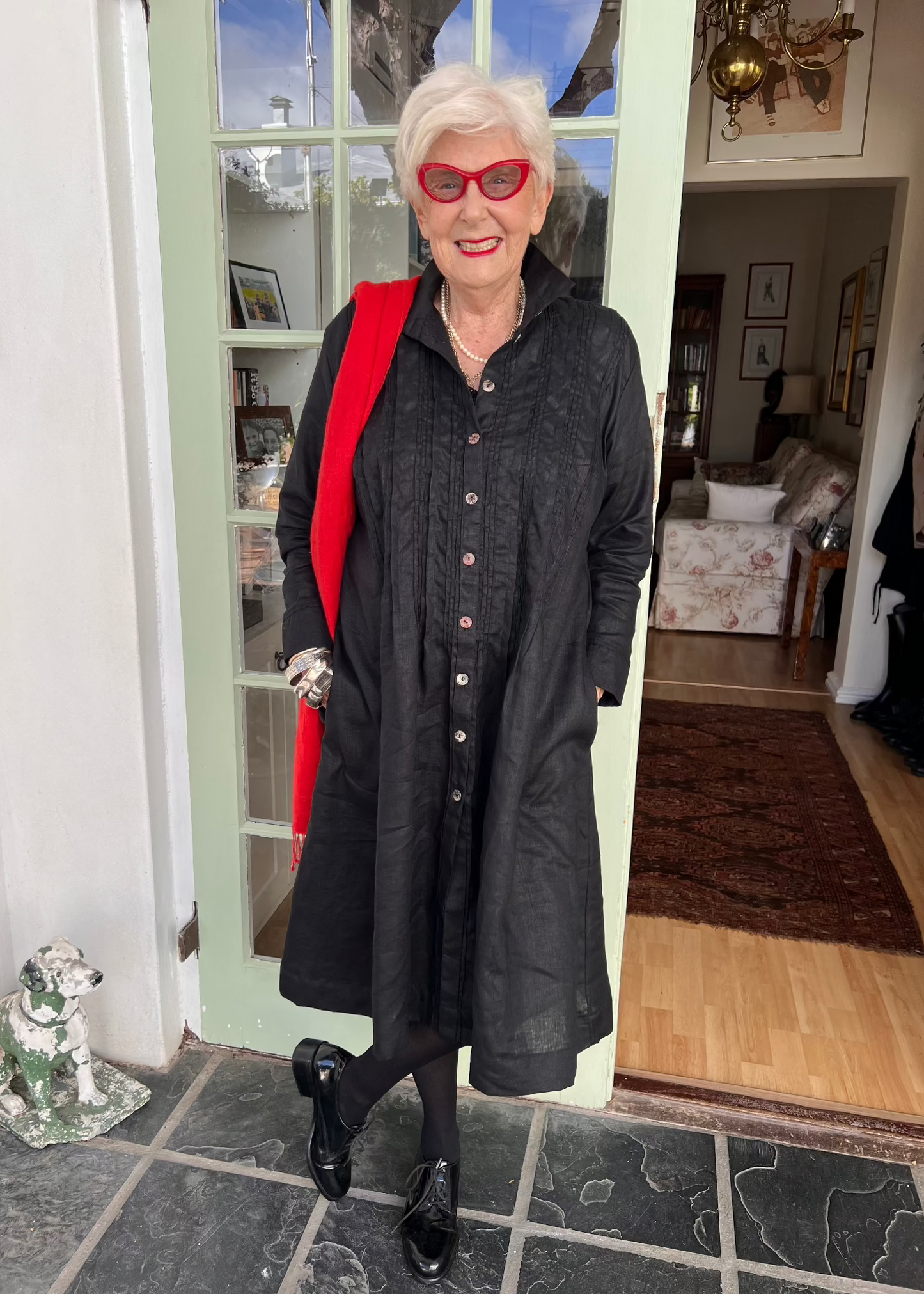 Crafted from breathable 100% pure linen, this effortlessly versatile dress transitions seamlessly through every season. Wear it solo with sandals for breezy summer days, layer it over a polo and tights when temperatures drop, or unbutton it completely to transform into a lightweight linen coat.