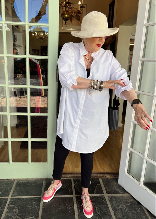 100% crisp cotton poplin women's shirt featuring dramatic back pleat with tied bow and decorative bow cuffs.