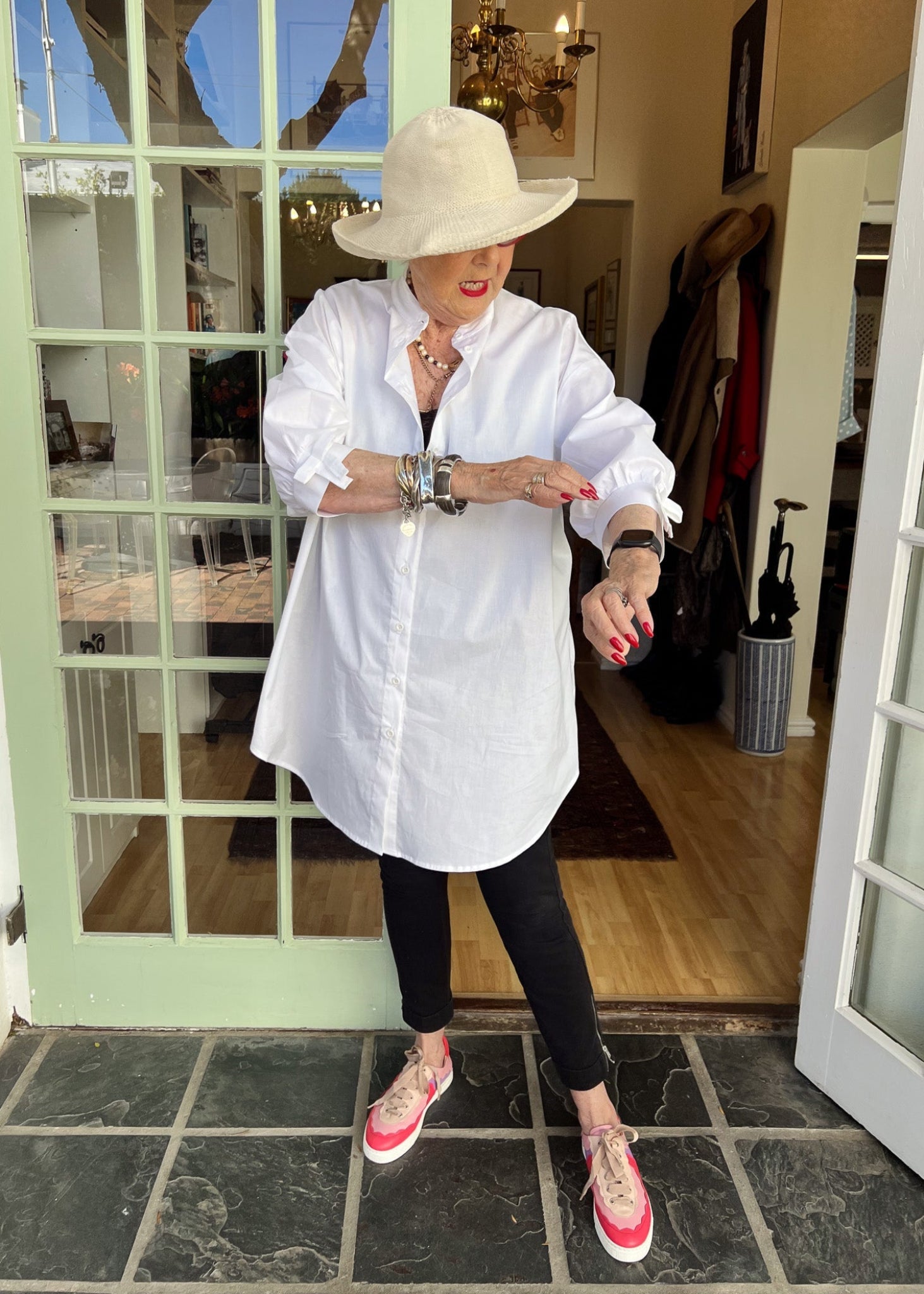100% crisp cotton poplin women's shirt featuring dramatic back pleat with tied bow and decorative bow cuffs.