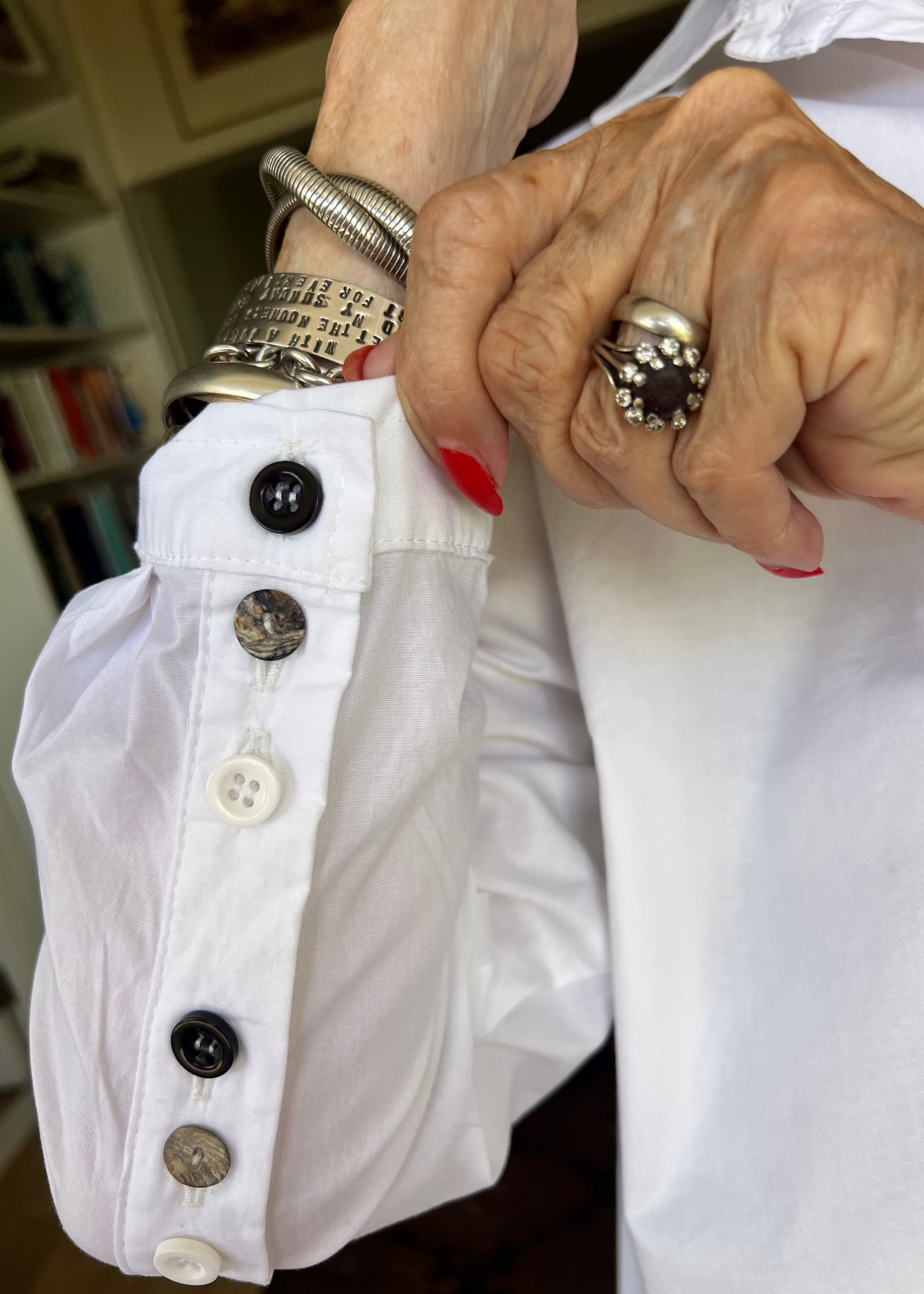 With its cheerful lineup of 26 buttons in three contrasting colours, this crisp cotton shirt brings a touch of whimsy to your everyday wardrobe. Designed with thoughtful asymmetry, it sits slightly shorter at the front and longer at the back - a clever detail that makes it the perfect partner for our Wide-Legged Pants.