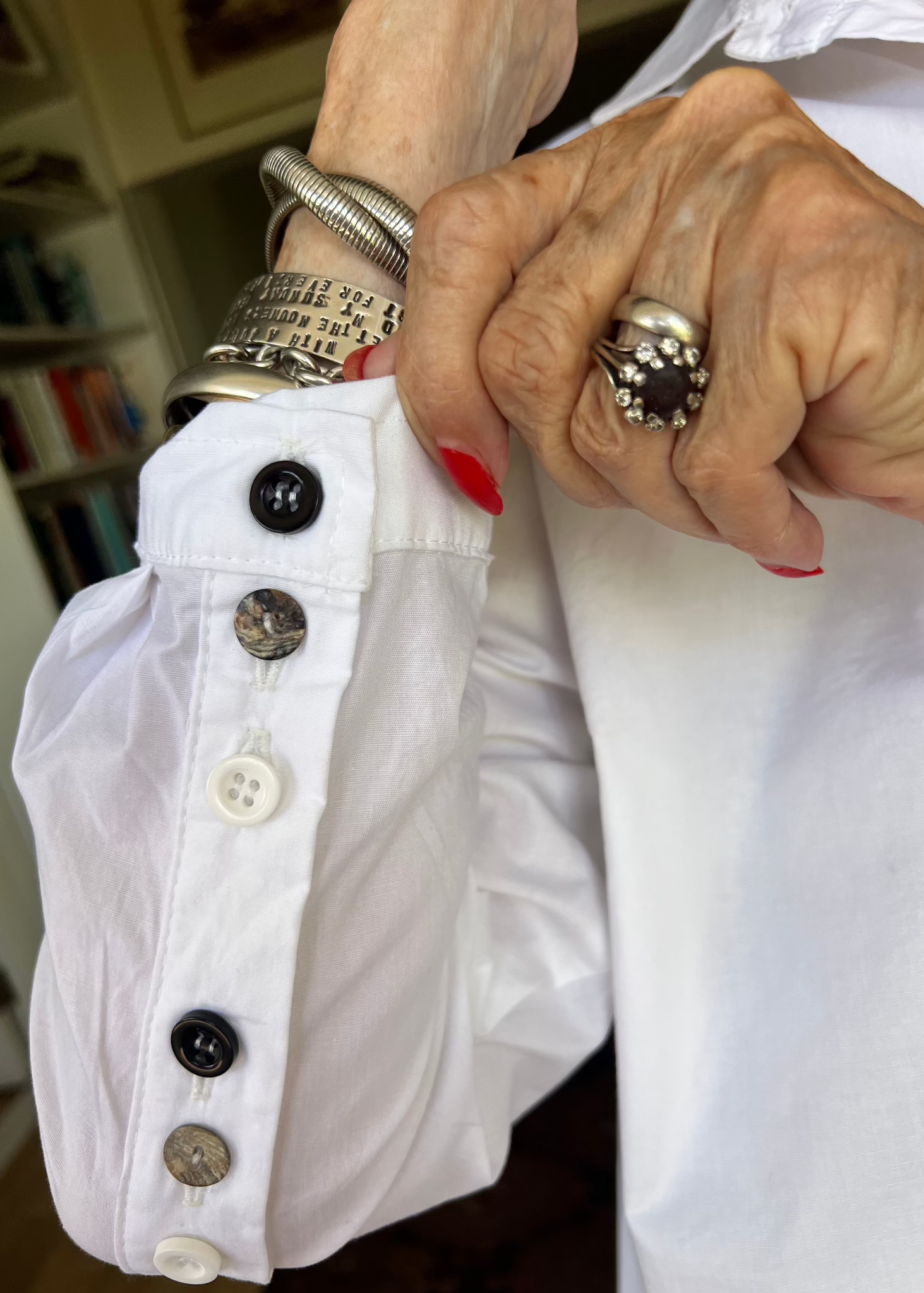 With its cheerful lineup of 26 buttons in three contrasting colours, this crisp cotton shirt brings a touch of whimsy to your everyday wardrobe. Designed with thoughtful asymmetry, it sits slightly shorter at the front and longer at the back - a clever detail that makes it the perfect partner for our Wide-Legged Pants.