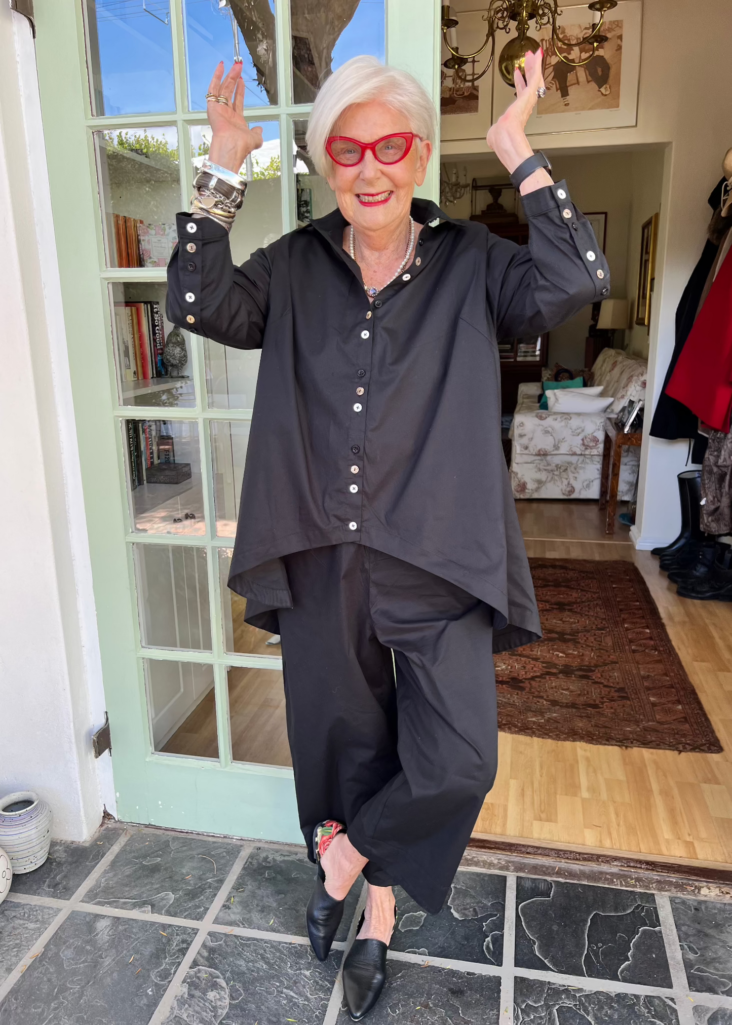 With its cheerful lineup of 26 buttons in three contrasting colours, this crisp cotton shirt brings a touch of whimsy to your everyday wardrobe. Designed with thoughtful asymmetry, it sits slightly shorter at the front and longer at the back - a clever detail that makes it the perfect partner for our Wide-Legged Pants.
