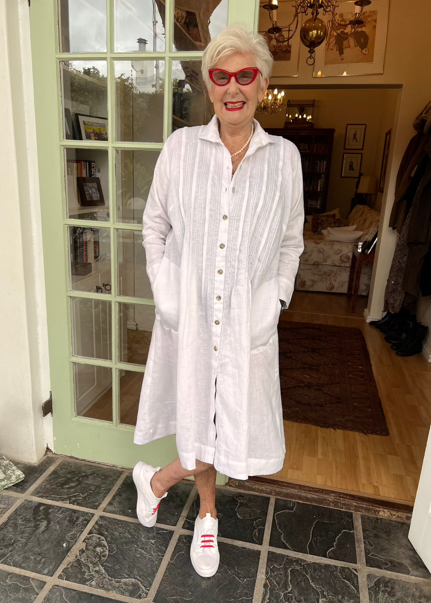 Crafted from breathable 100% pure linen, this effortlessly versatile dress transitions seamlessly through every season. Wear it solo with sandals for breezy summer days, layer it over a polo and tights when temperatures drop, or unbutton it completely to transform into a lightweight linen coat.