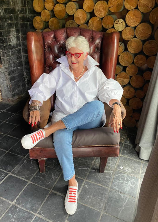 Jenny le Roux wearing a crisp white 100% cotton shirt, with a hint of a puff sleeve.